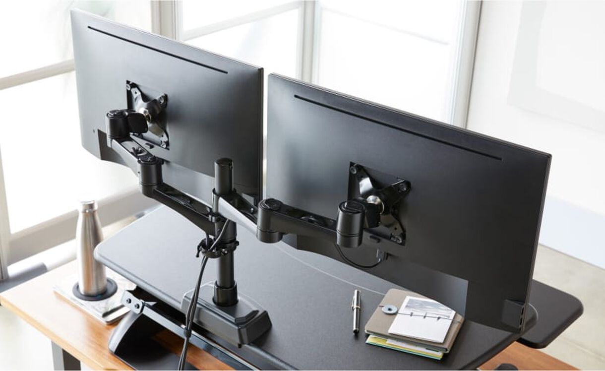 monitor arms installed on a desk